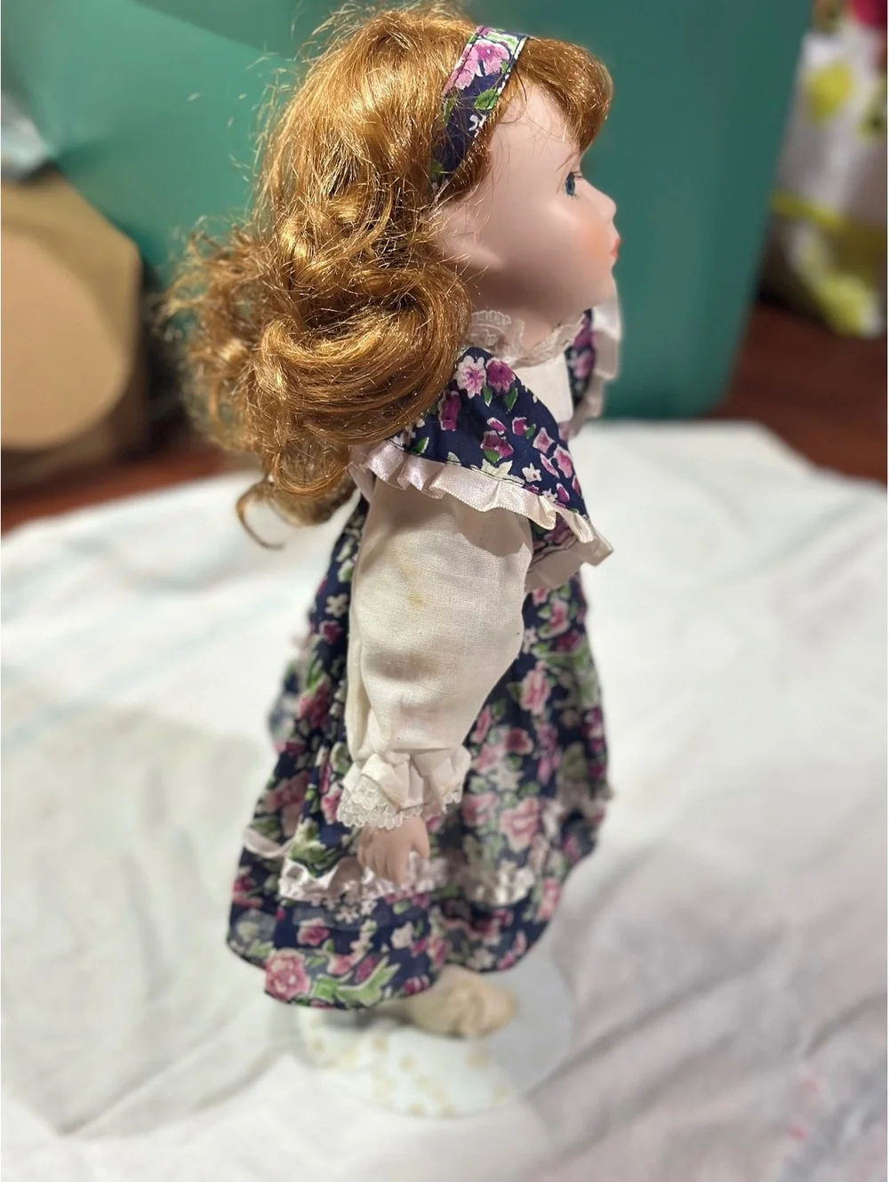Vintage Porcelain Doll with Floral Dress and Curly Red Hair